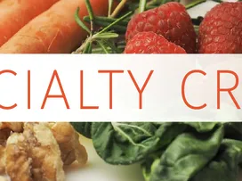 Carrots, raspberries, spinach and walnuts with overlaid text "SPECIALTY CROPS"