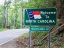 Welcome To NORTH CAROLINA sign with NC flag; TRANSYLVANIA CO county sign