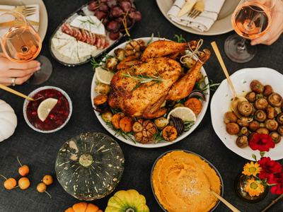 spread of holiday foods like turkey and pumpkins in dishes on a table