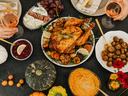 spread of holiday foods like turkey and pumpkins in dishes on a table