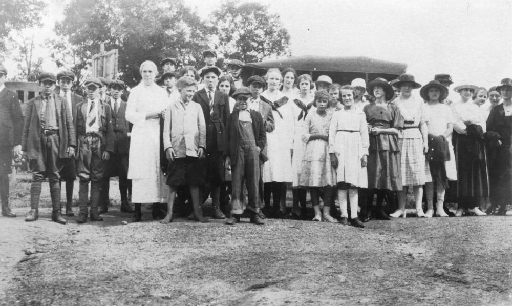 Photo of women, men, and children attending 4H camp in 1921.