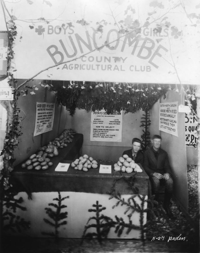 Black and White Photo of two boys at the NC State Fair's Buncombe County Agricultural Clubs display in 1922.