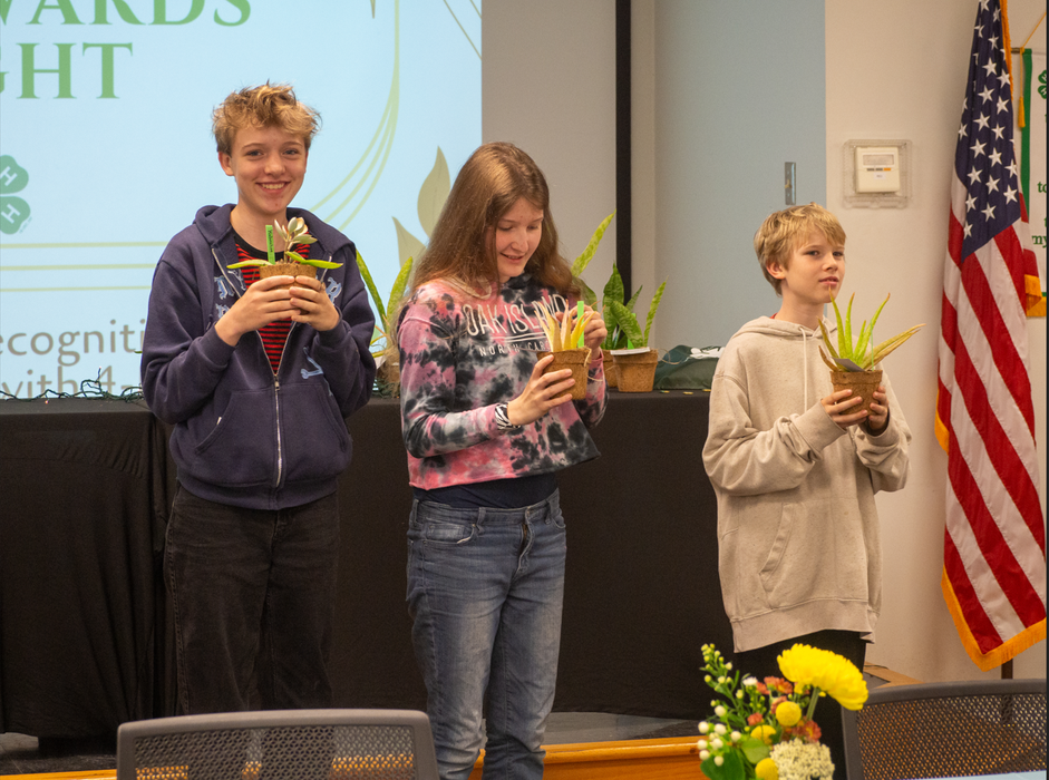 three 4-H youth receiving their awards