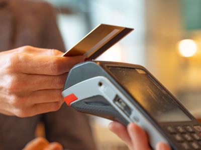 A person pays using a credit card with Tap to Pay.