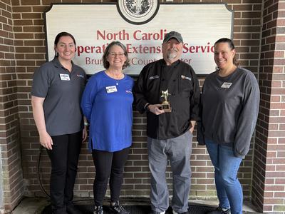 From left to right: Emily Pendergrass (Regional Nutrition Extension Associate) Angie Lawrence (EFNEP Nutrition Educator, 4-H Program Assistant) Chef John LaTour, and Jamie Lester (4-H Youth Development Agent).