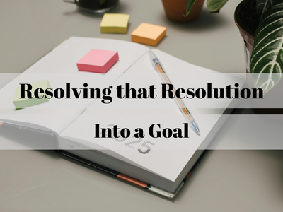 Open planner with pen, sticky notes, and plant; text: "Resolving that Resolution Into a Goal"