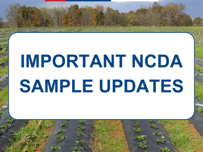 Field with mulched crop rows and sign: "IMPORTANT NCDA SAMPLE UPDATES" with NC Cooperative Extension logo