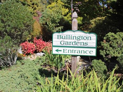 Bullington Gardens sign reading "Entrance" with left arrow among garden plants