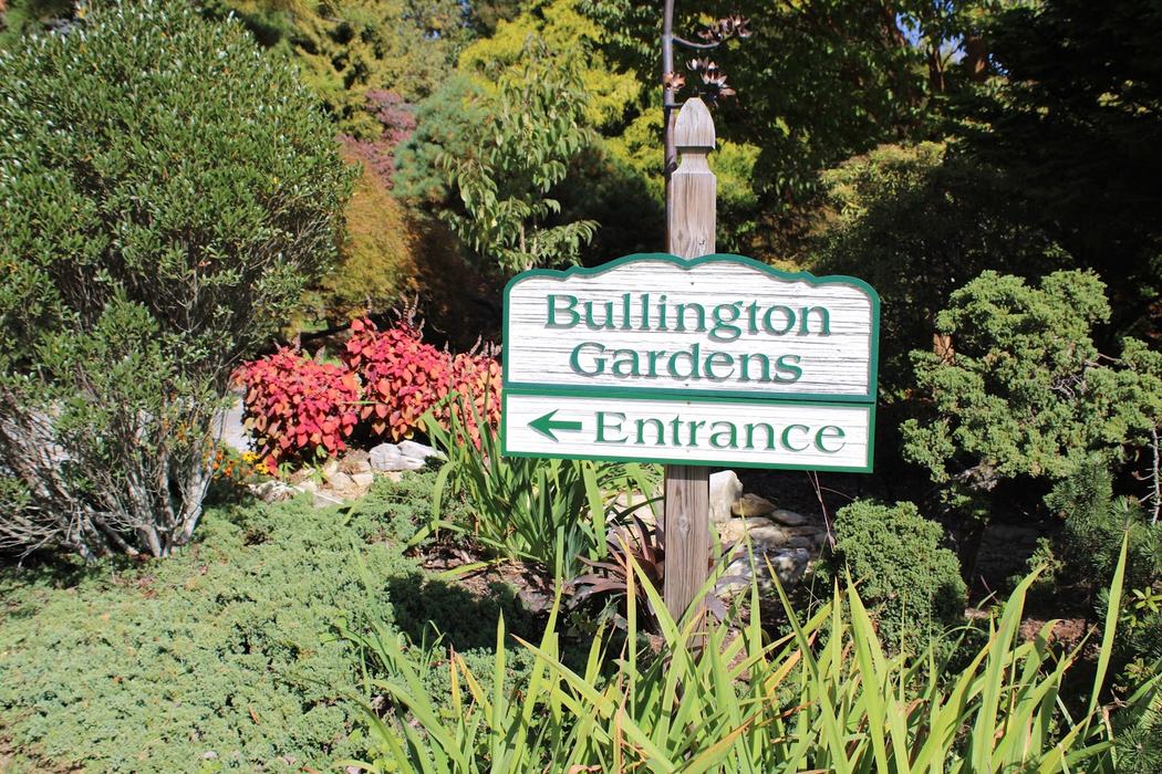Bullington Gardens sign reading "Entrance" with left arrow among garden plants