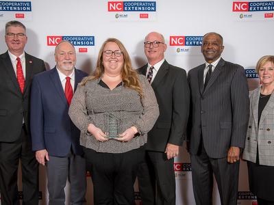 Group photo of Abby Whitaker and NCSU and NC A & T Extension Administration