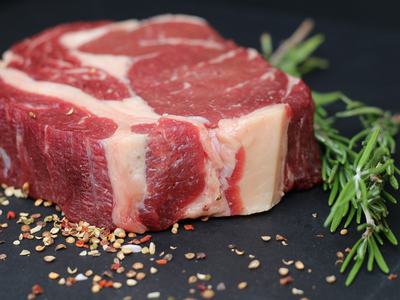 raw steak with peppercorn and herbs
