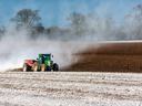 Tractor spreading lime on field