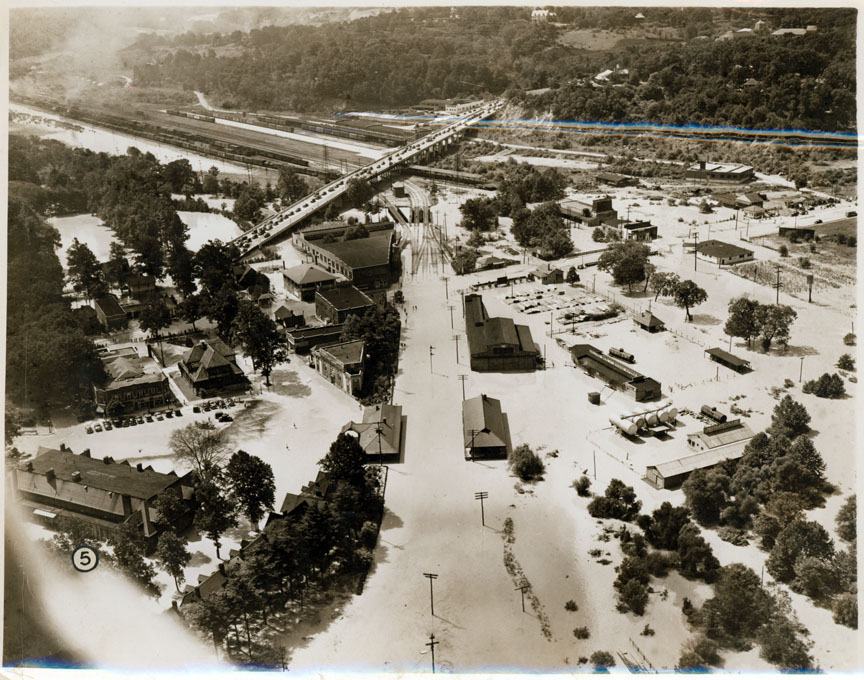 1940 newspaper photo showing Biltmore Village and the McDowell Street bridge after flooding. Note the railroad tracks under water in the center of this photo. 