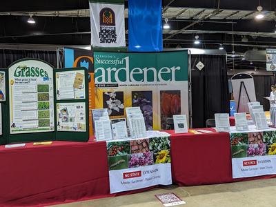 NC State Extension "Successful Gardener" booth with "Grasses" display and pamphlets.