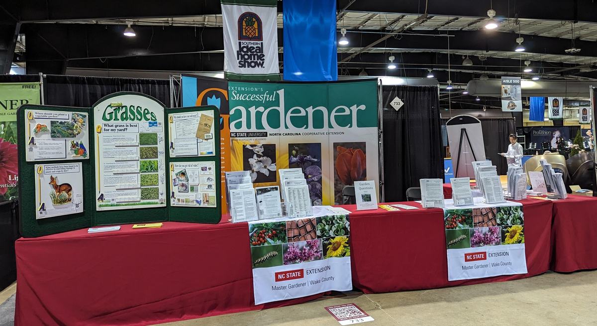 NC State Extension "Successful Gardener" booth with "Grasses" display and pamphlets.