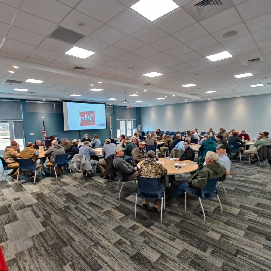 room fullof farmers discussing research.