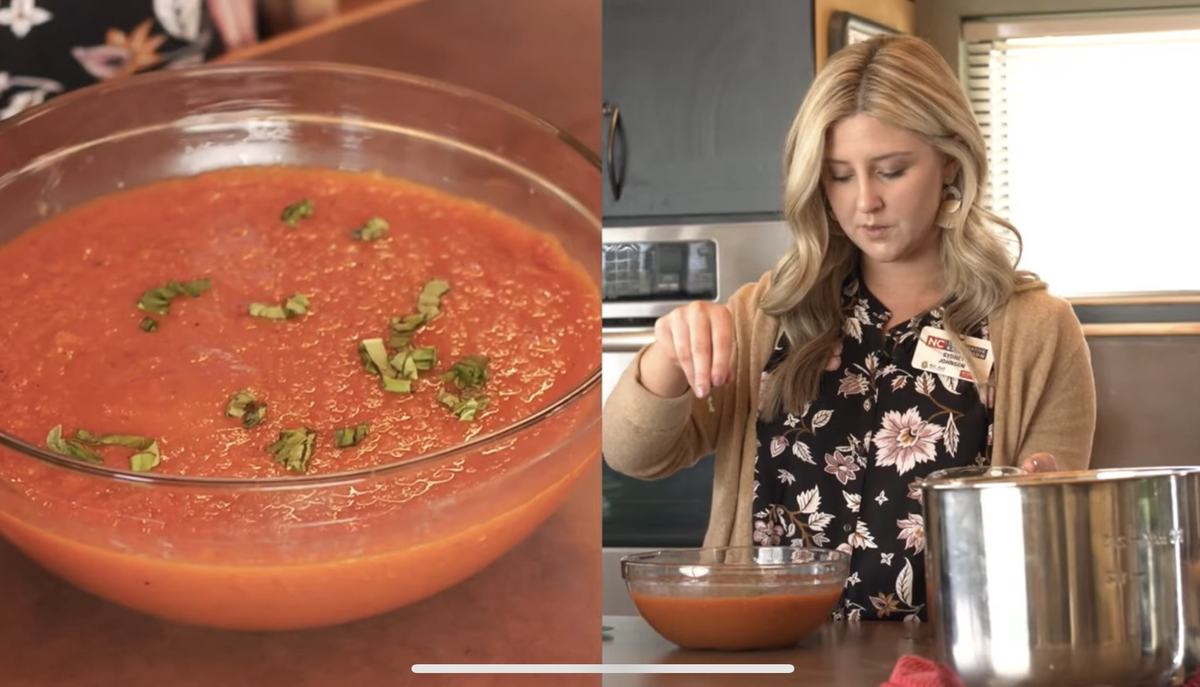 A woma prepares a tomato dish.