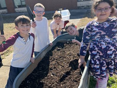 Kids standing around Raised Garden Bed