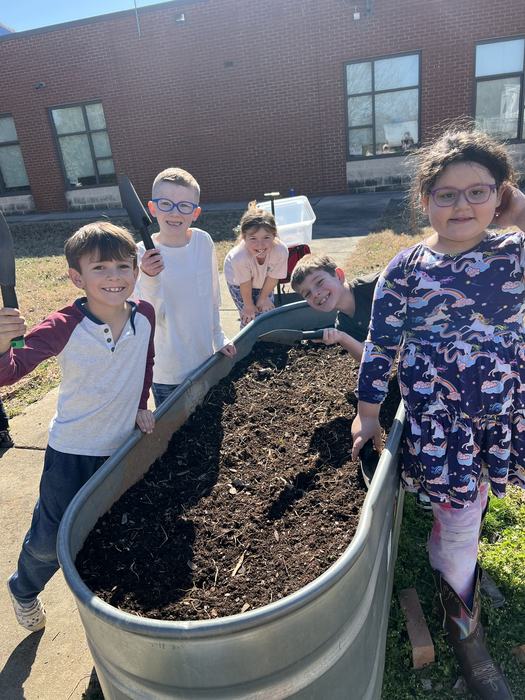 Kids standing around Raised Garden Bed