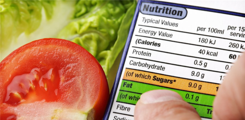 nutrition food label next to a sliced tomato and piece of lettuce