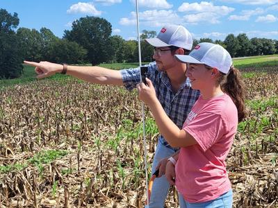NC State Extension agent Morgan Menaker works with a Wingate University intern to set up a plot for research into seeding rates and planting dates for cereal rye cover crops.