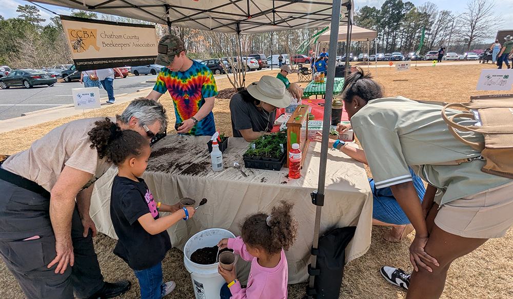 Master Beekeeper Lori Hawkins with the Chatham County Beekeepers' Association brought a honey bee observation hive and some pollinator plants for the kids to plant.