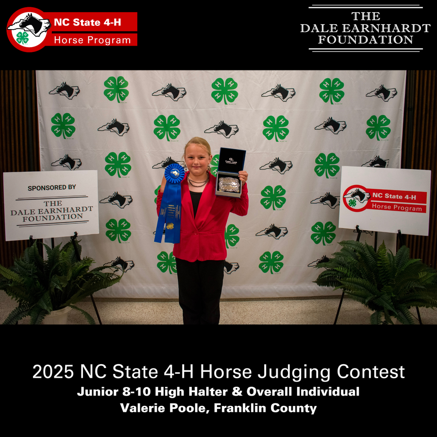 Girl holding blue ribbon and belt buckle in front of 2025 NC State 4‑H Horse Judging Contest backdrop, Valerie Poole