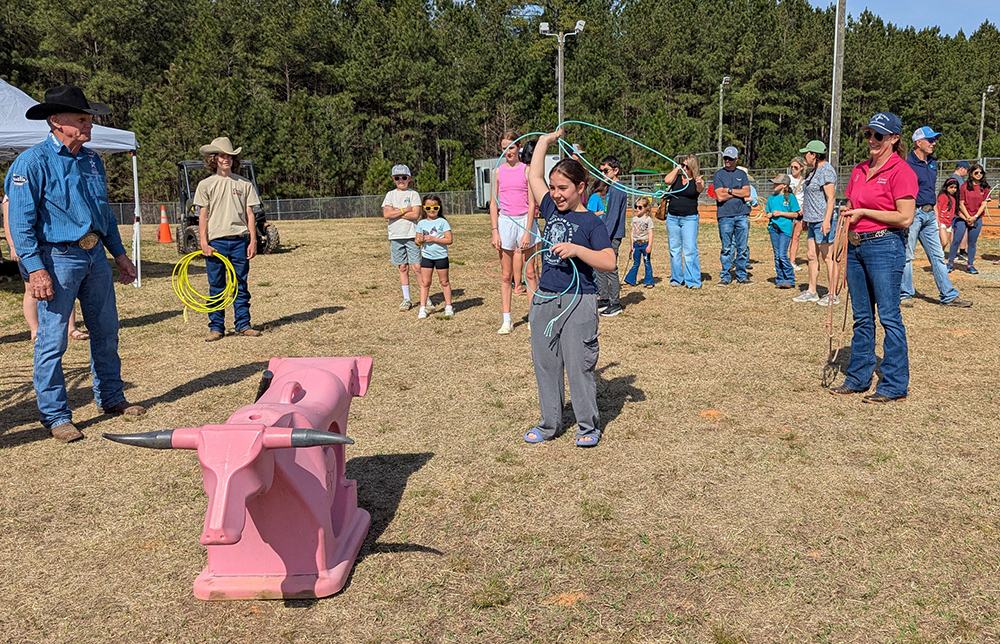 The smiles, giggles, and encouragement were abundant during the kids' roping practice. A few adults tried it out too!