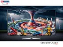 TV showing tornado with vehicles, rockets, robots; labels: NC Cooperative Extension; Senior Planet from AARP