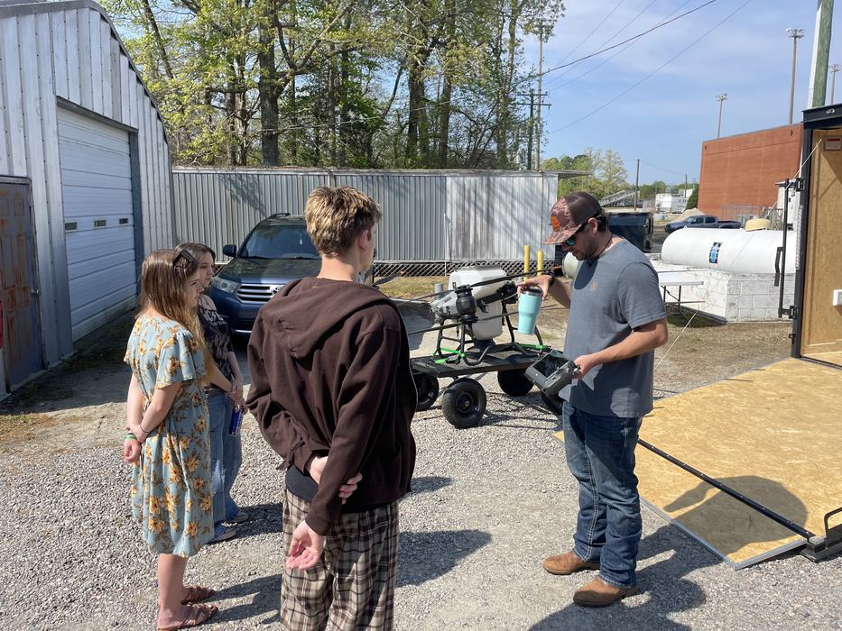 A man shows off his sprayer drone.