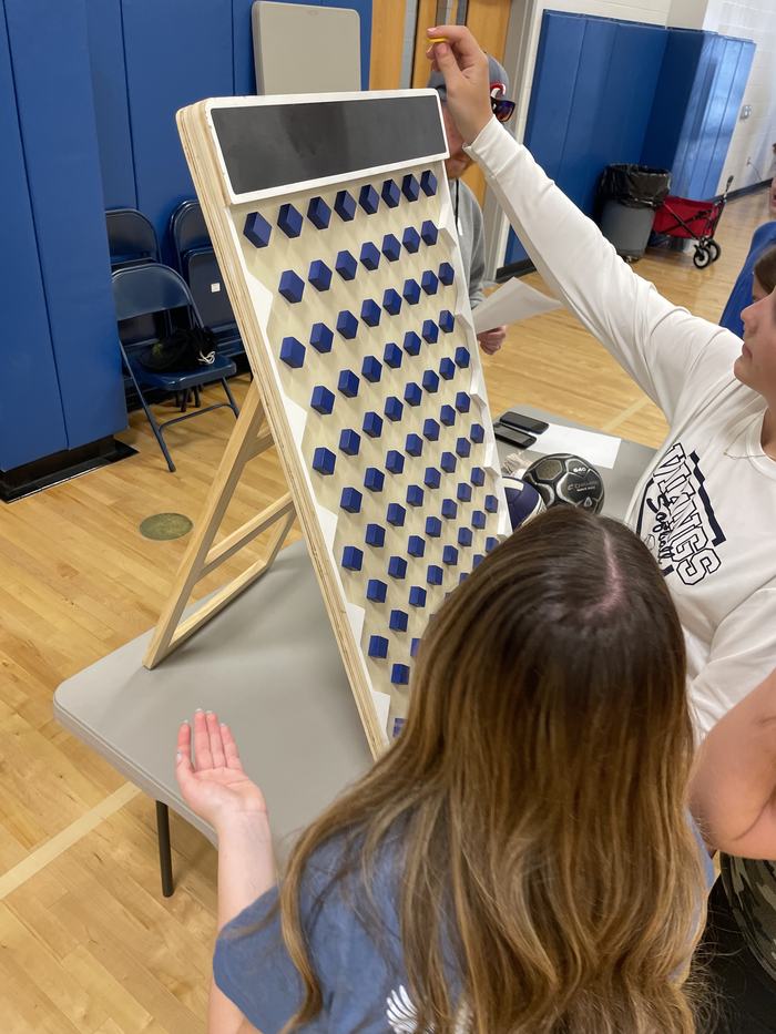 Children playing a version of Plinko