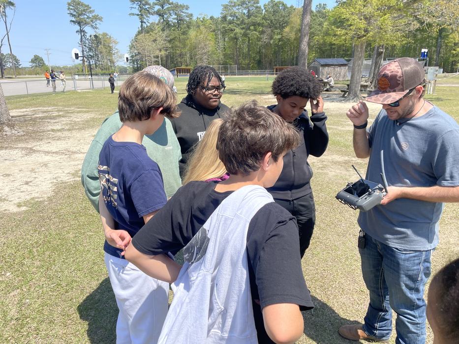 Children review controls for a large drone.