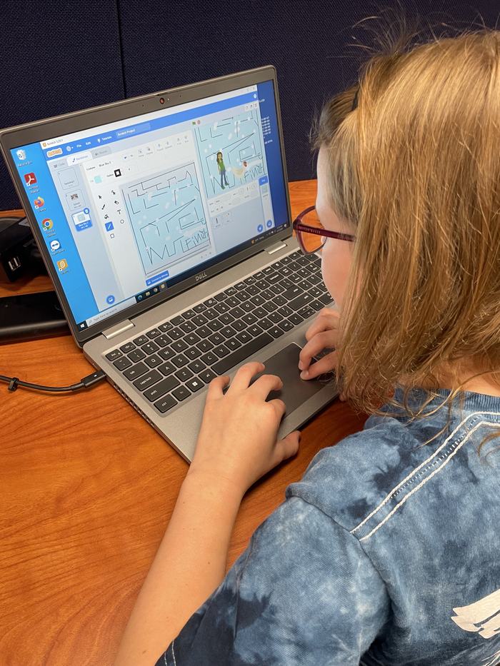 A girl designs a maze for her game.