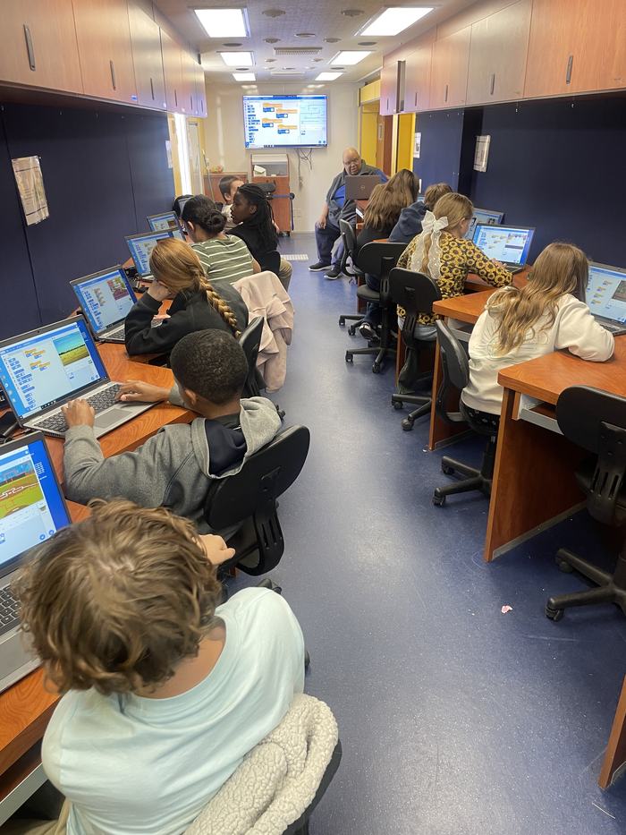 Children work away at creating games together.