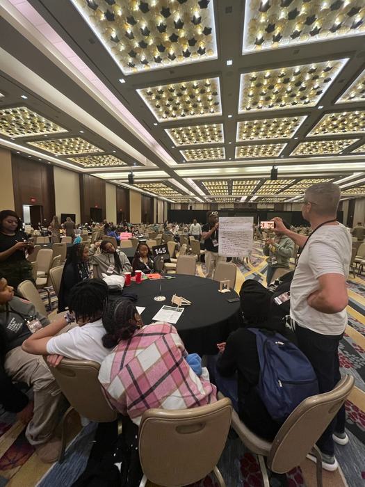 A ballroom full of 4-Her's working together.