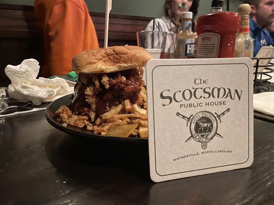 A burger with a "The Scotsman Public House"coaster.