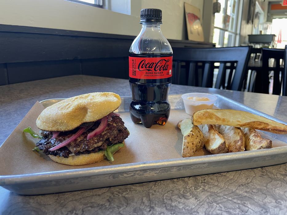 Burger and potato wedges with a coke.