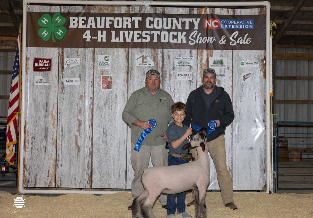 youth with animal and buyer