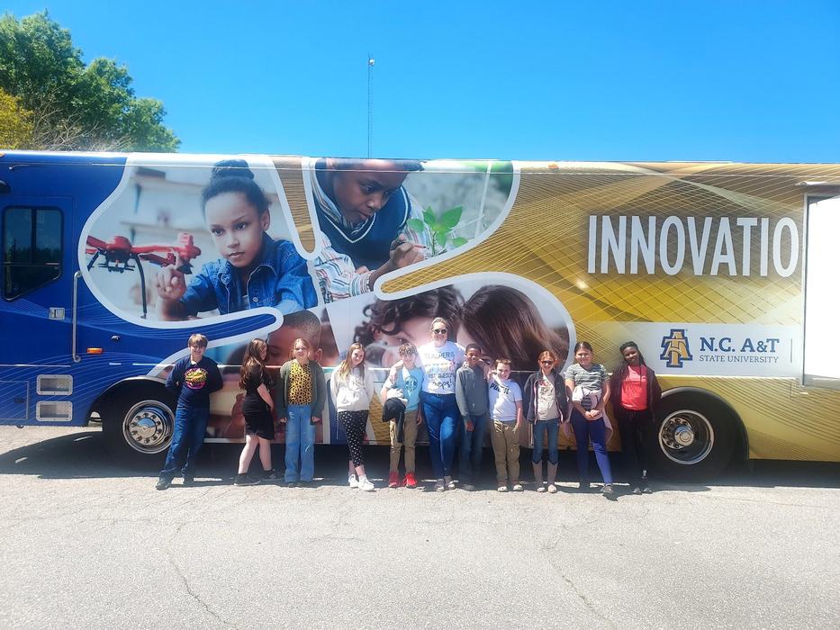 A 4-H group poses in front of the Innovation Station.