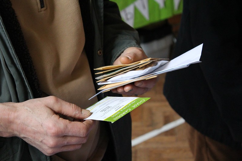 A woman holding packets of seeds.