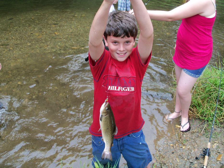 boy fishing with trout