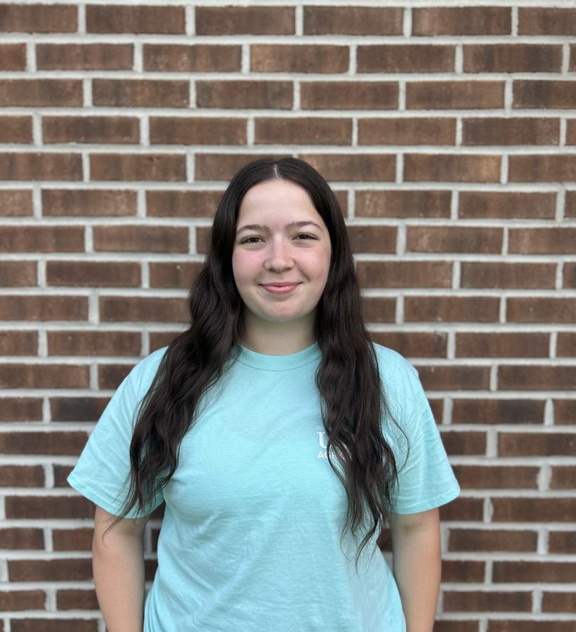 image of Whitney in front of brick wall