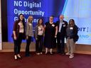 Six members of N.C. Cooperative Extension’s Digital Futures team standing together and smiling at the NC Digital Opportunity Gathering in April 2025.