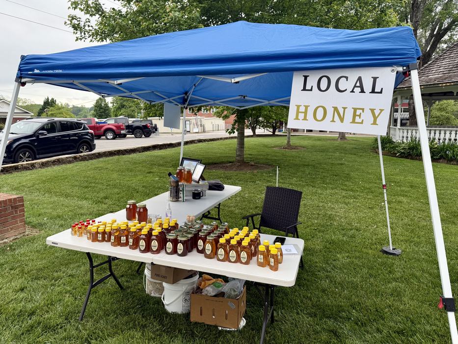 A tent selling Local Honey.
