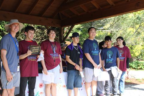 Students stand together to receive awards.