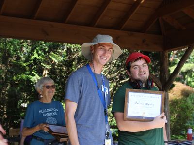 Two students receive an award.