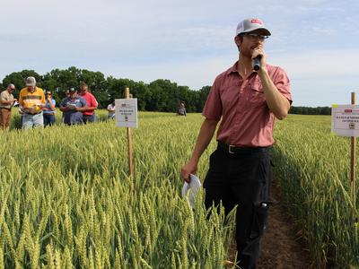 Morgan talking to crowd in wheat field