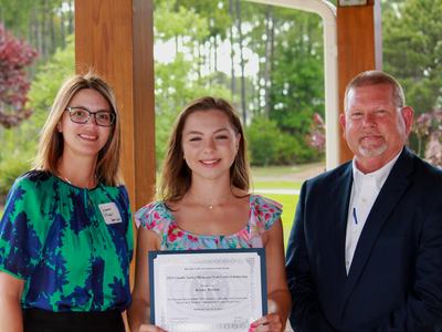from left to right: Savanna Sillings (Teen Court Program Assistant), Keona Warren (scholarship recipient) and Sam Davis (Teen Court Director)
