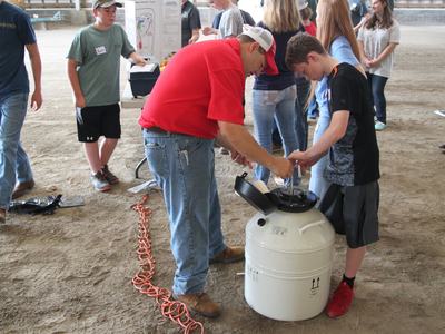 A child learns from an adult as part of a Skillathon Clinic.