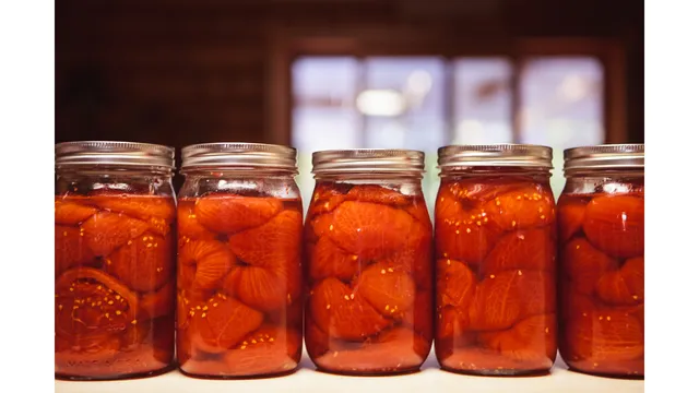 row of jars of canned tomatoes